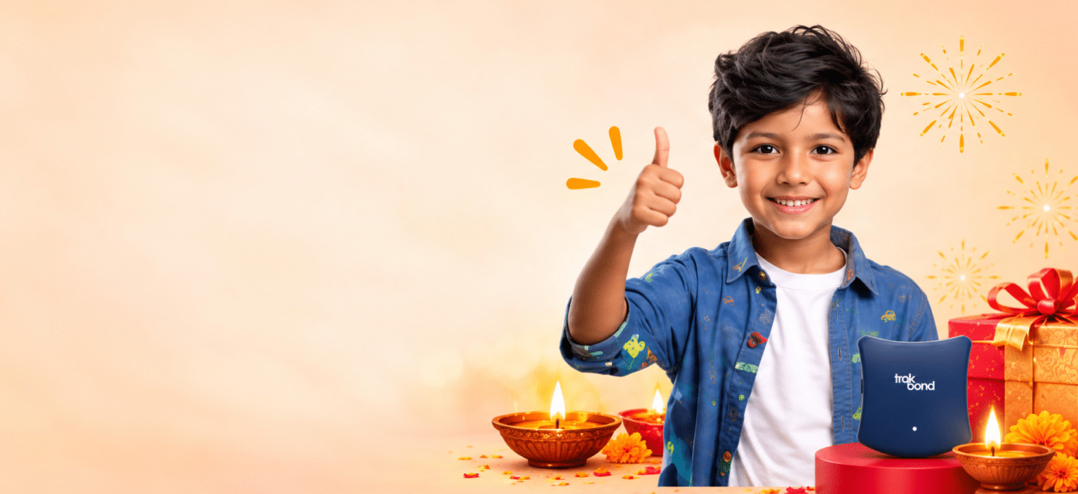 Smiling child giving a thumbs up beside a blue Trakbond GPS tracker
